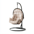 Fauteuil suspendu en rotin avec coussin beige et support en acier
